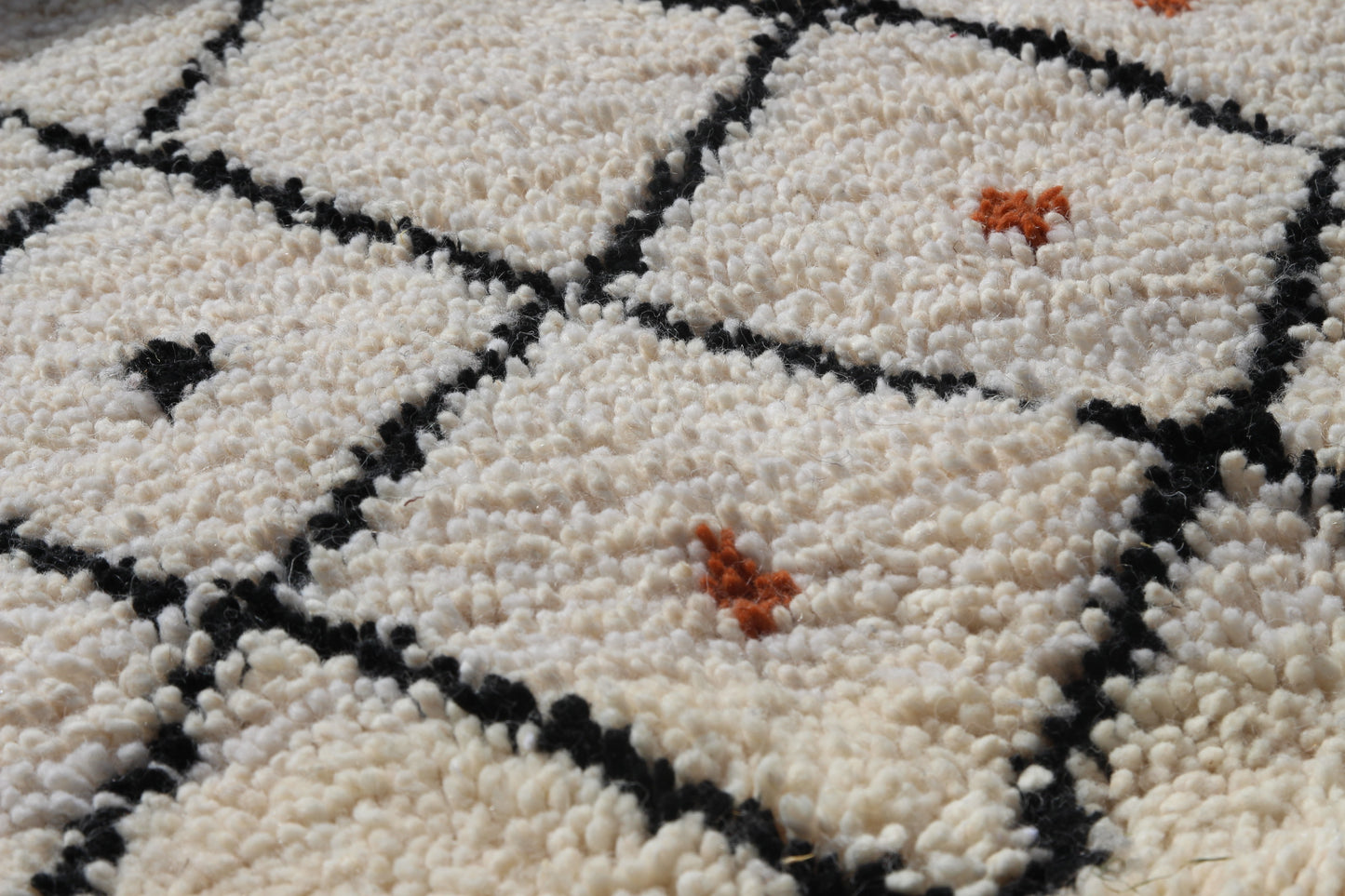Close-up of a textured rug with geometric pattern